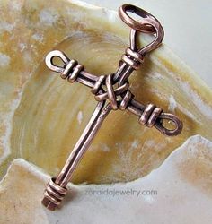 a cross is sitting on top of a marble slab with a chain attached to it