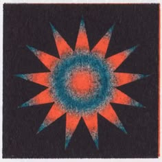 an orange and blue sunburst on a black background in the middle of a square