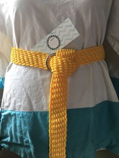 a person wearing a yellow belt with a tag on it