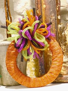 an orange and purple wreath sitting on top of a table