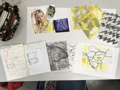 several pieces of art are spread out on a table with papers and pencils next to them