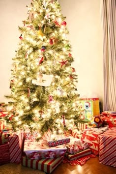 a christmas tree with presents under it