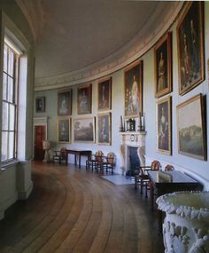 a large room with many paintings on the wall