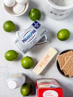 ingredients to make an ice cream dessert including limes, graham crackers and marshmallows