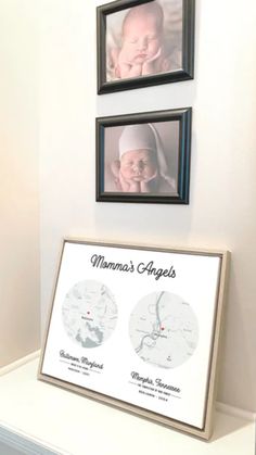 two framed pictures hang on the wall above a baby's crib