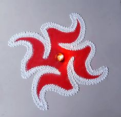 a red and white design on the ground with a light in it's center