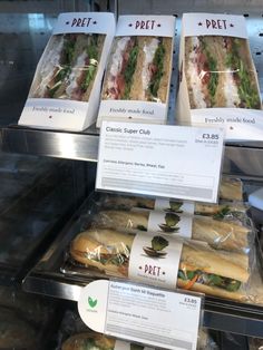 sandwiches are on display in a deli case