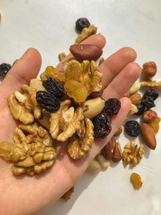 a hand full of nuts and raisins