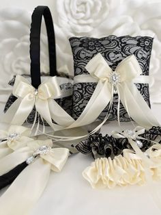 two black and white wedding garters, one with satin ribbons and the other with bows