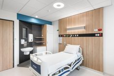 a hospital room with a bed and sink