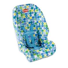 a child's car seat with blue and green polka dots