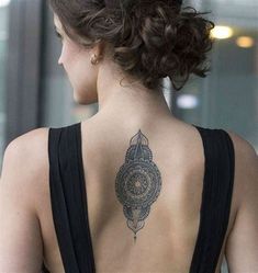 a woman with a tattoo on her back