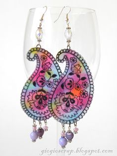 a pair of pink and purple paisley earrings