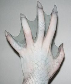 a person's hand is covered in white paint