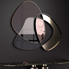 a mirror that is on the side of a wall next to a shelf with two vases