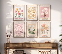 four flower posters on the wall above a table