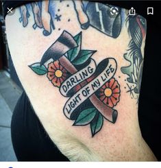 a woman with a tattoo on her stomach has an image of a cross and flowers