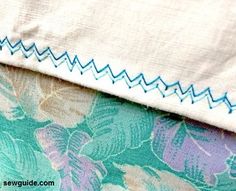 closeup of the stitching on an upholstered piece of fabric with blue thread