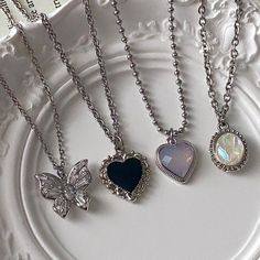 four different necklaces on a plate