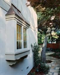 an outside view of a house with a tree in the yard