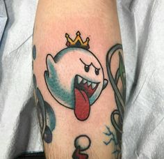 a cartoon character with a crown on his head and tongue sticking out from behind it