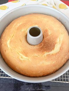 a bundt cake in a white pan on a cooling rack