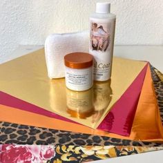 the contents of a beauty product sitting on top of a leopard print table cloth and towel