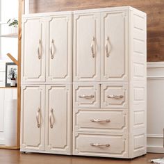 a large white cabinet sitting on top of a hard wood floor