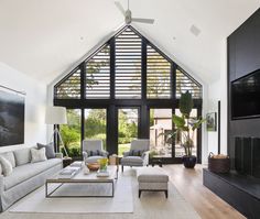 a living room with couches, chairs and a fireplace