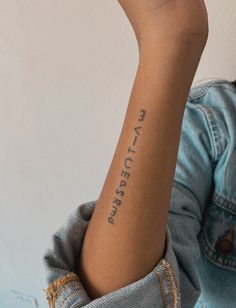 a woman with a tattoo on her arm