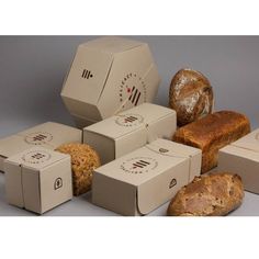 an assortment of breads and loaves are shown in this image with the box open