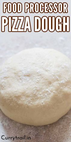 a pizza dough sitting on top of a counter next to a spatula with the words food processor pizza dough