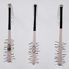 three bats are hanging upside down in the air with spikes sticking out of it's sides