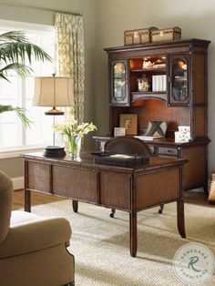 a living room filled with furniture and a book case on top of a wooden desk