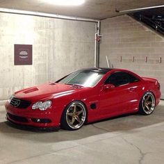 a red sports car parked in a parking garage