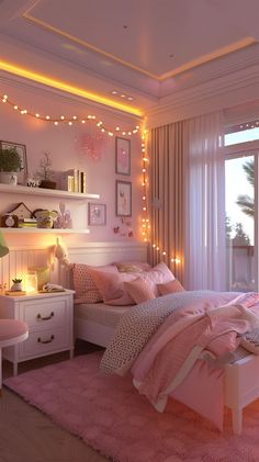 a bedroom decorated in pink and white with fairy lights