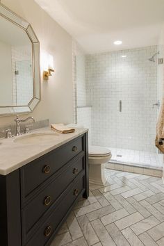 a bathroom with a sink, toilet and shower