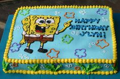 a spongebob birthday cake on a blue tablecloth with yellow trimmings