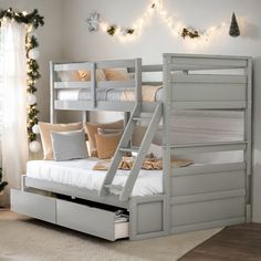 a white bunk bed sitting next to a christmas tree