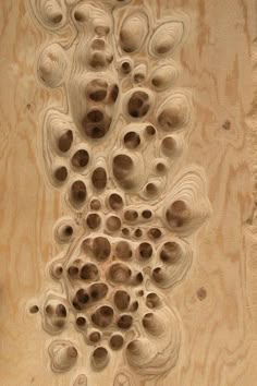 an intricately carved piece of wood with holes in it