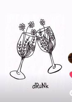 two wine glasses with flowers on them and the word drunk written in black ink next to it