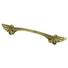 an antique brass drawer pull handle on a white background with clipping to the left