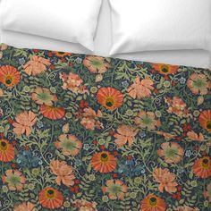 an image of a bed with flowers and leaves on the comforter cover that is made up