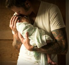 a man holding a baby in his arms