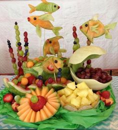 a table topped with fruits and vegetables on top of a green tray covered in fruit