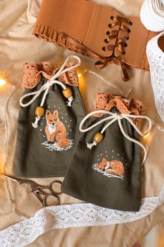 two bags with foxes on them sitting next to some scissors