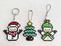 three christmas themed key chains are shown on a table