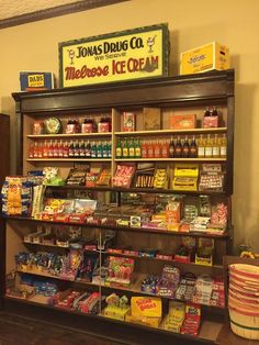 a store filled with lots of different types of food and drinks on shelves next to a wall