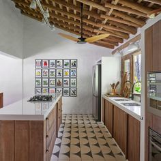 a kitchen with tiled flooring and wooden ceiling