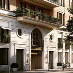 an apartment building with balconies and plants on the balcony